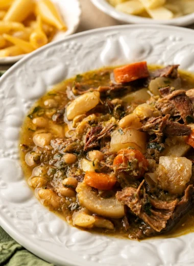 Bowl of comforting French Garbure, a hearty cabbage stew with vegetables and meat.