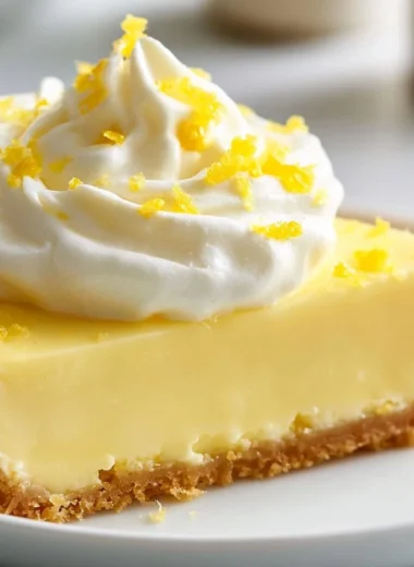 Delicious creamy lemon tart garnished with fresh lemon slices.