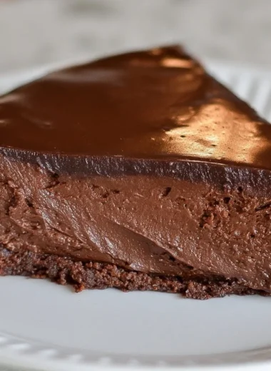 Rich and moist Decadent French Chocolate Cake topped with chocolate ganache