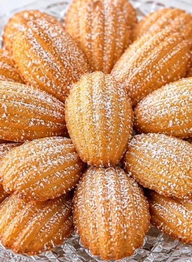 A batch of Traditional French Madeleines fresh out of the oven, perfect for tea time.