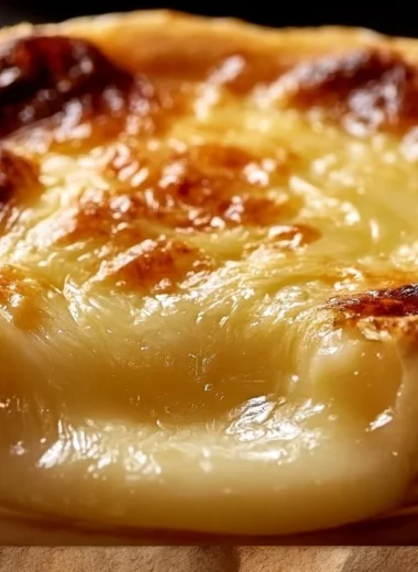 Oven-baked Mont d'Or cheese served in a wooden box with fresh bread.