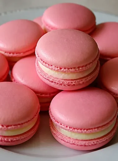 Basic French macarons displayed on a decorative plate.