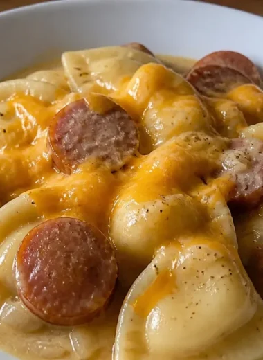 Creamy crockpot pierogi casserole with kielbasa served in a dish